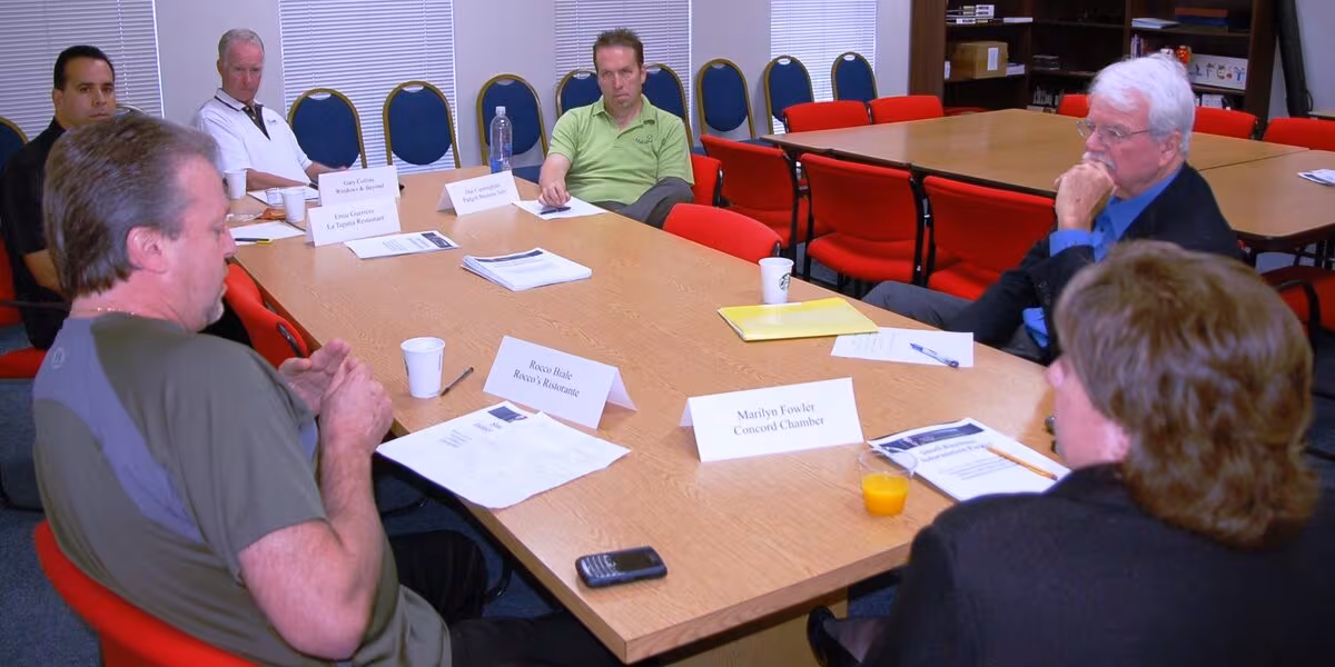 Reunión de empresarios alrededor de una mesa de trabajo